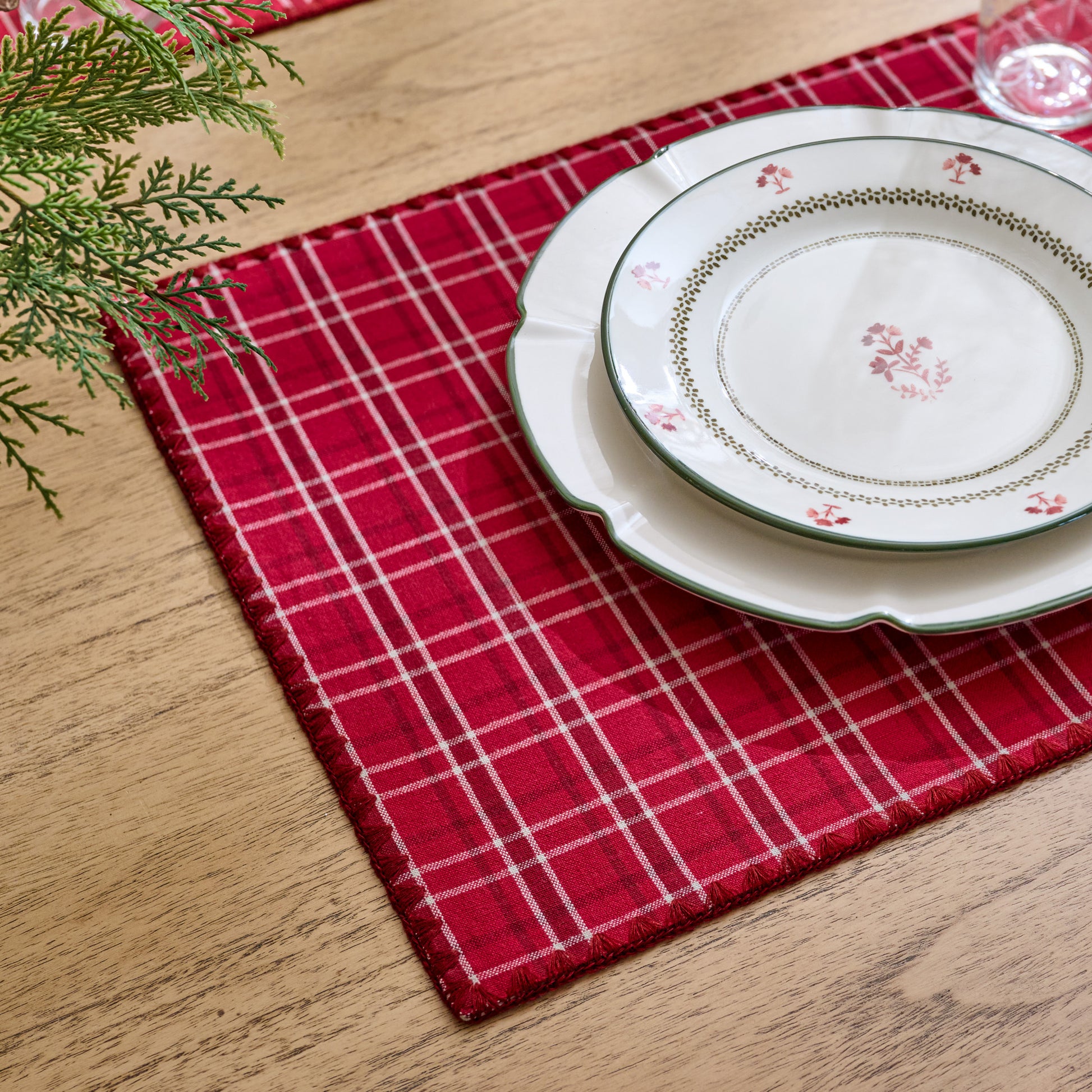 Magnolia Festive Plaid Reversible Placemat Set of Four - red side showing set on table