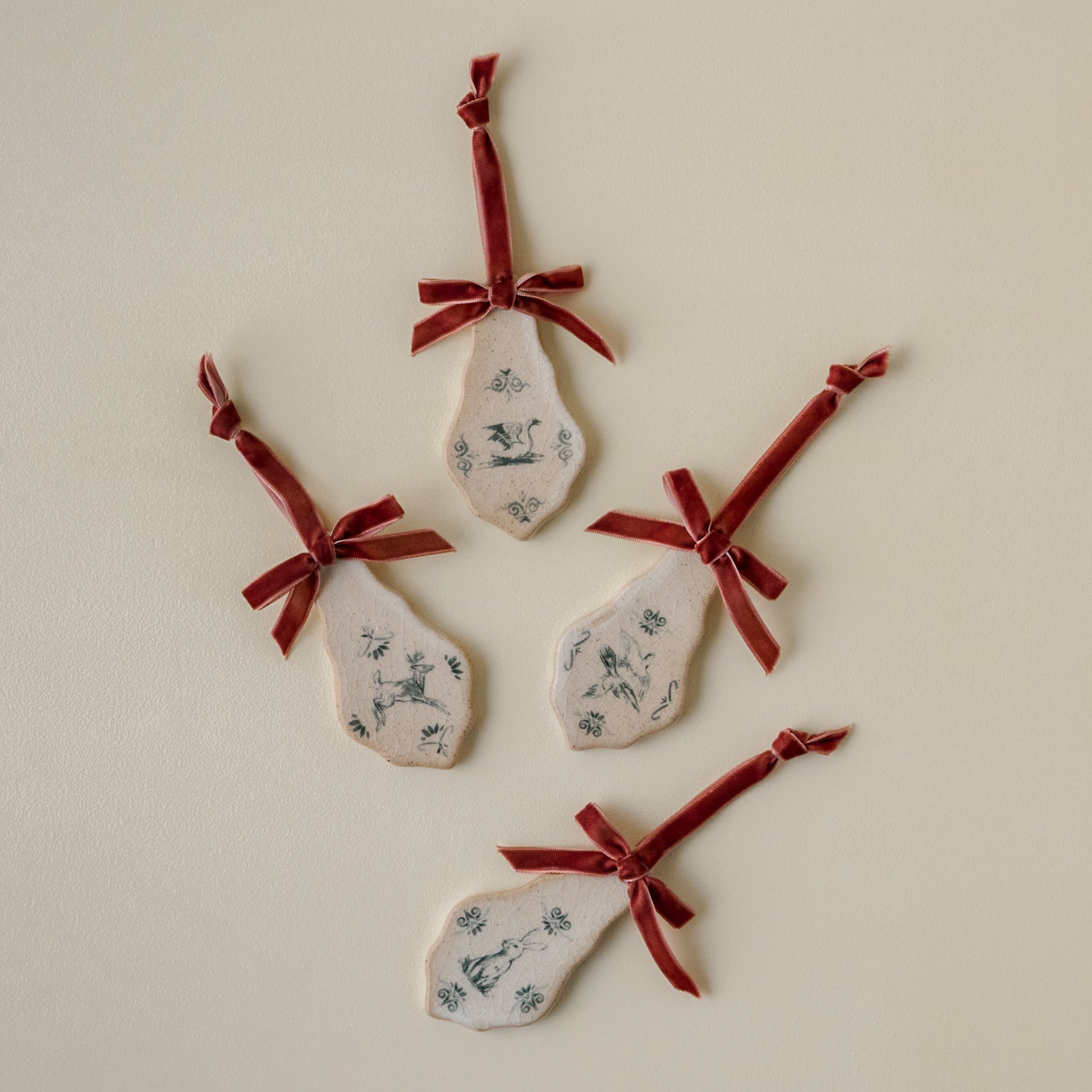 Enchanted Forest Tile Ornaments with red velvet ribbons and animal sketches