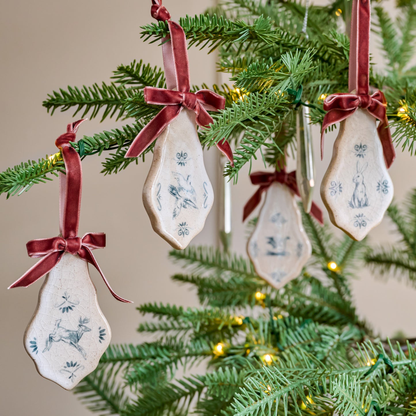 Enchanted Forest Tile Ornaments with red velvet ribbons and animal sketches