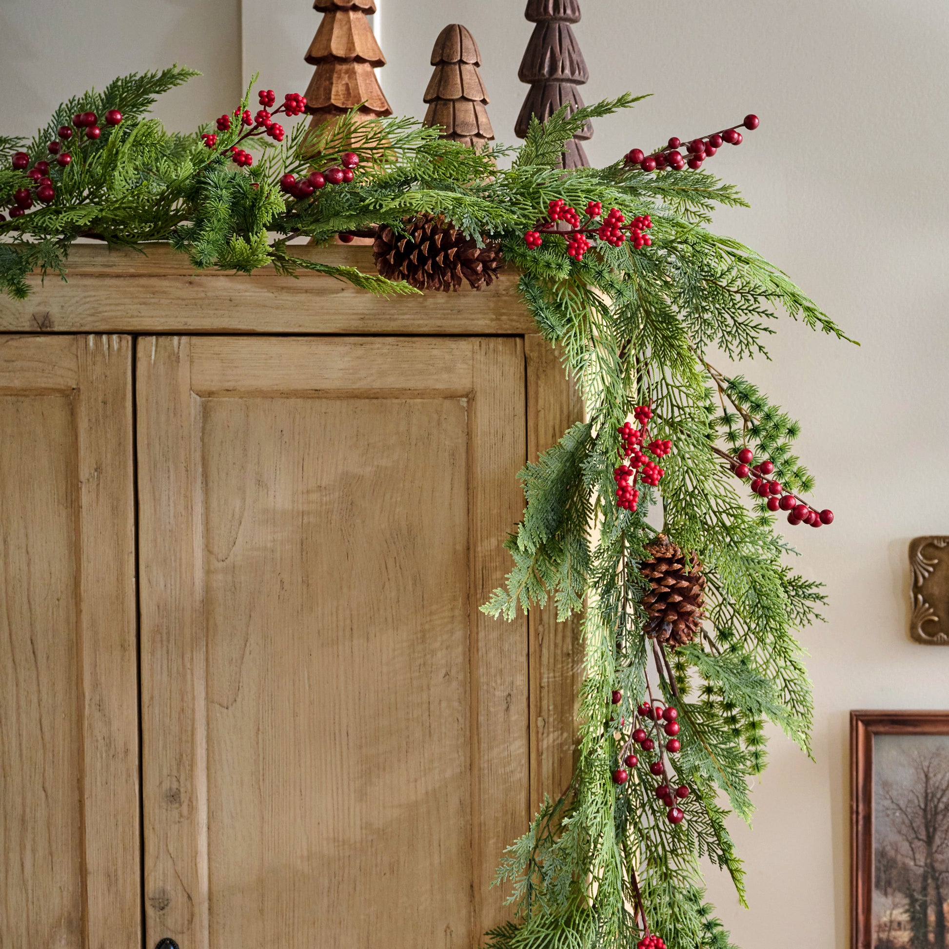 Real Touch Foraged Red Berry Pine Garland - 72" shown on cabinet