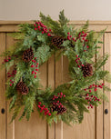 Real Touch Foraged Red Berry Pine Wreath shown on cabinet