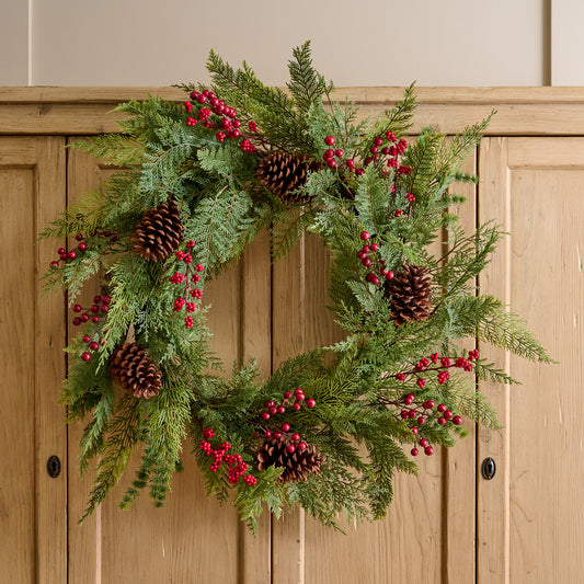 Real Touch Foraged Red Berry Pine Wreath shown on cabinet