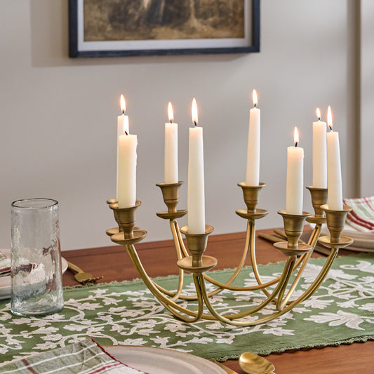 Antique Brass Stacking Candelabra shown on table with candles