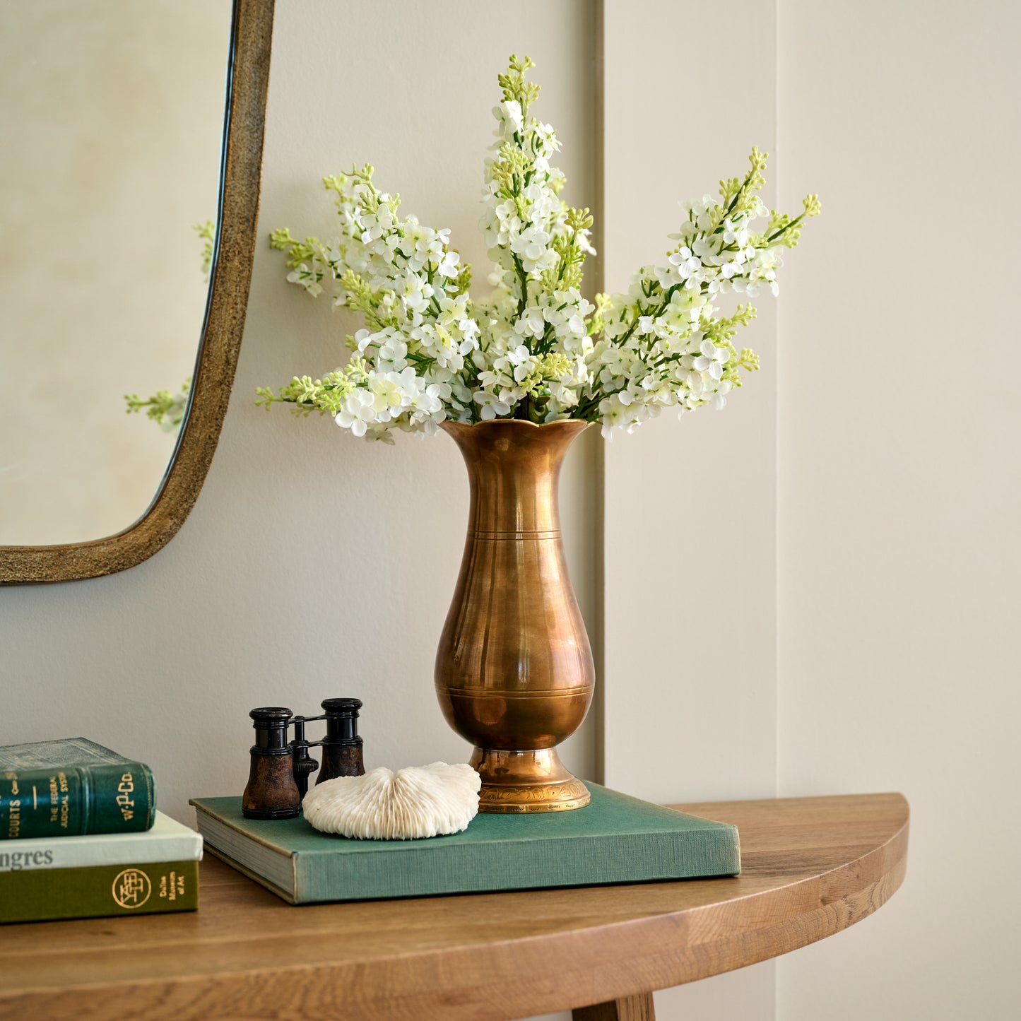 Anna Antiqued Solid Brass Vase (large) with white floral stems on console table