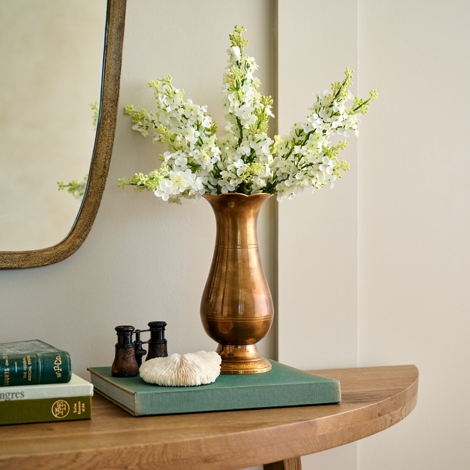 Anna Antiqued Solid Brass Vase (large) with white floral stems on console table