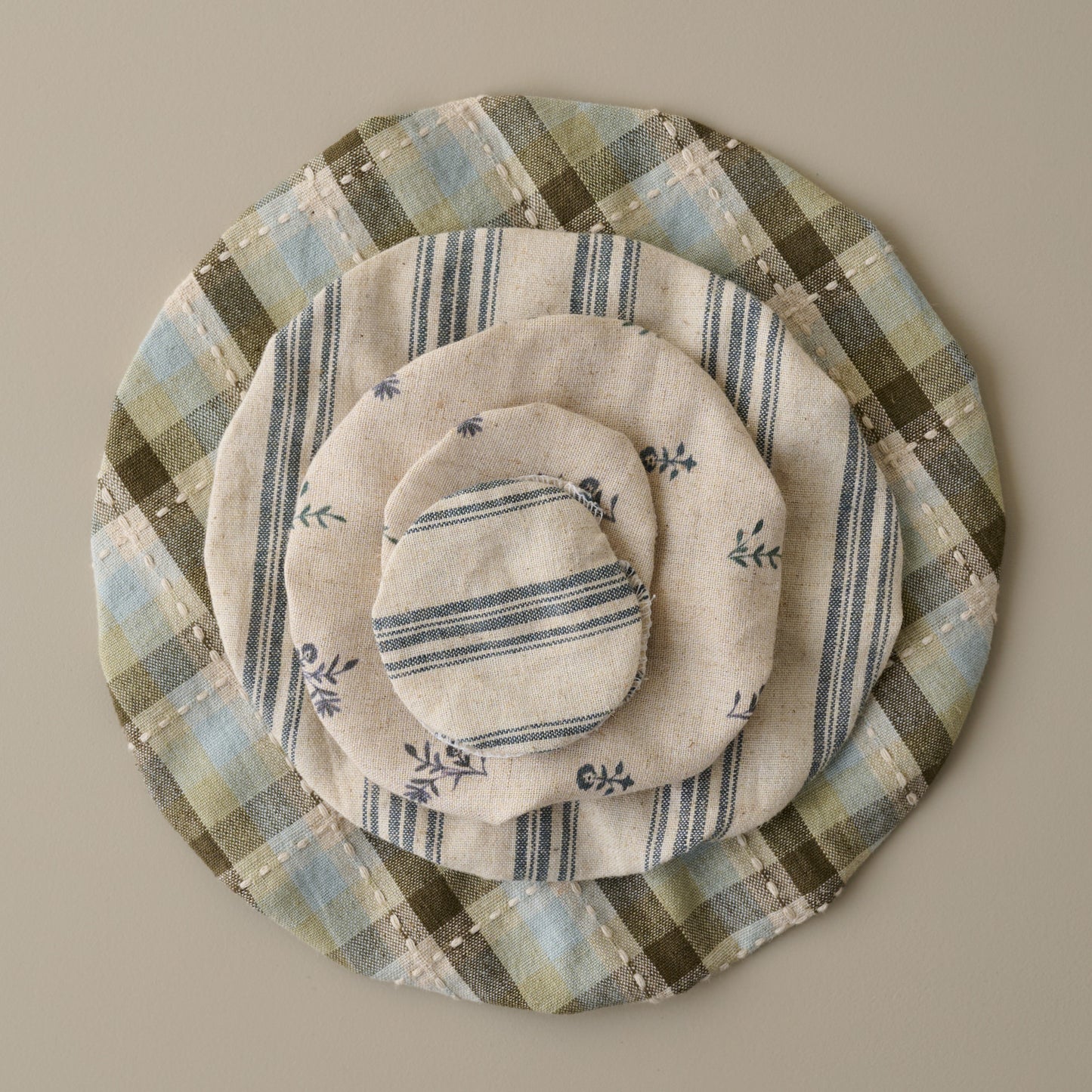 Magnolia Bread + Jar Cover Set of Five stacked on top 