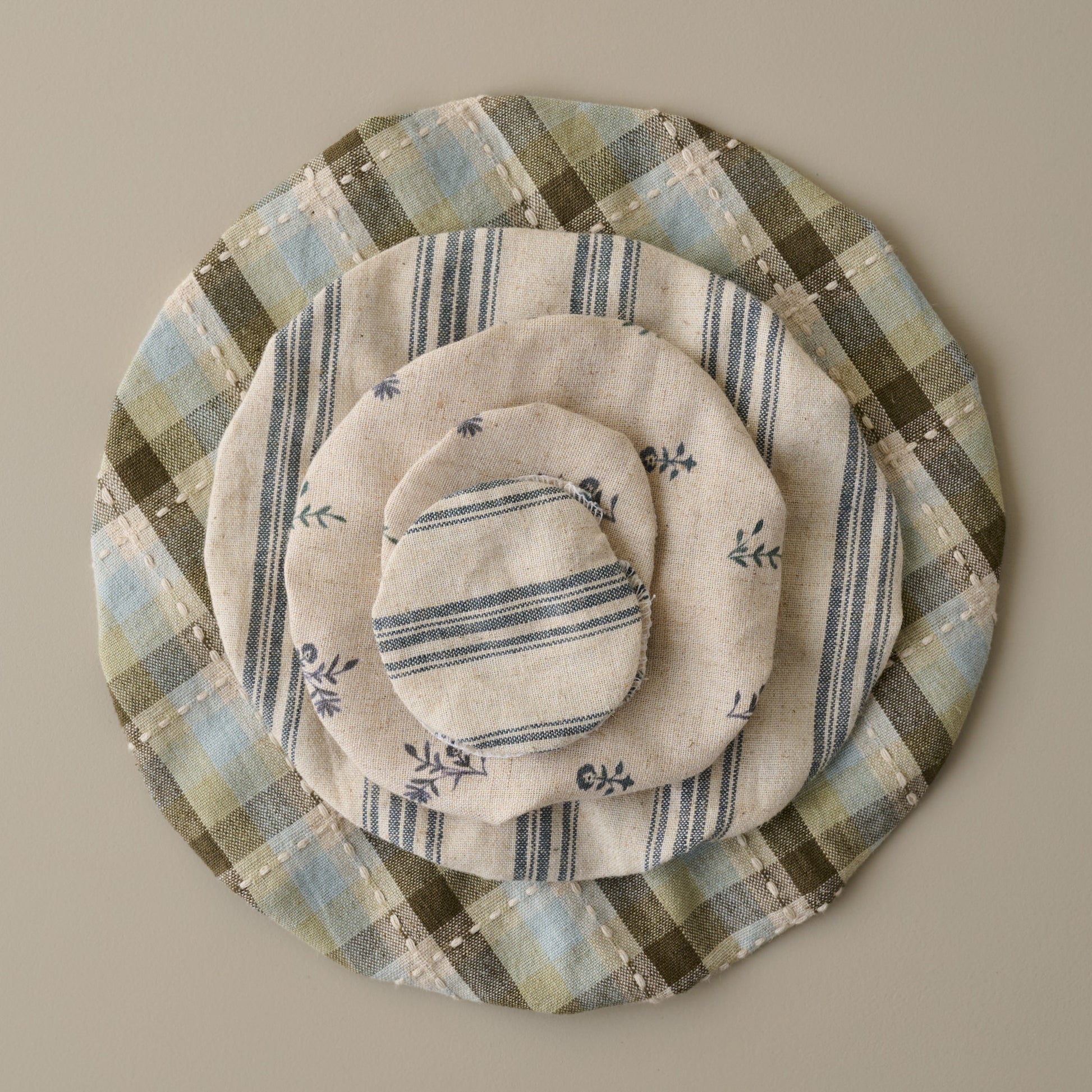 Magnolia Bread + Jar Cover Set of Five stacked on top 