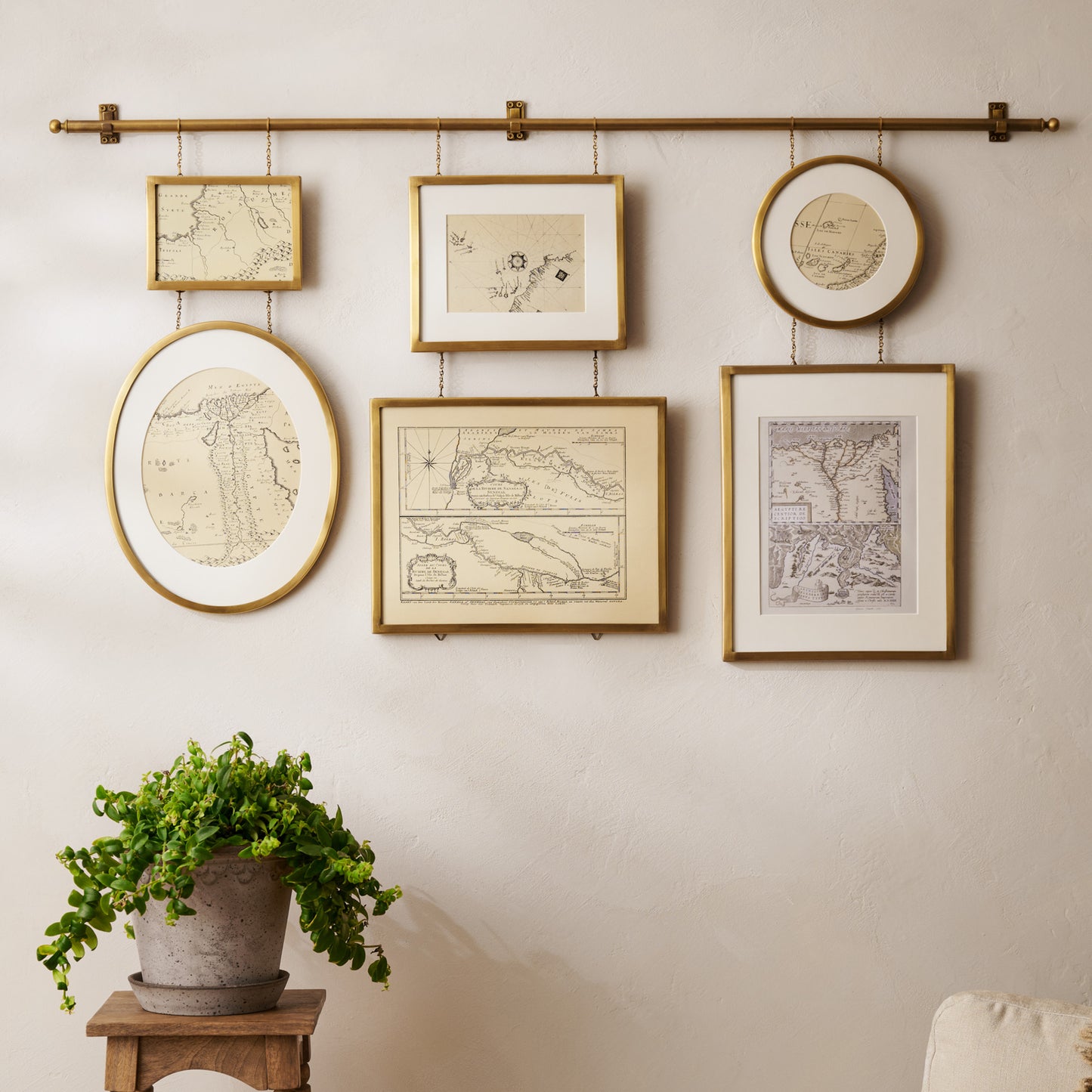 Colleen Brass Rail Photo Gallery styled in a room above plant stand
