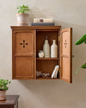 Amelia Wooden Wall Cabinet styled with decorative accents, garden plants and coffee table books