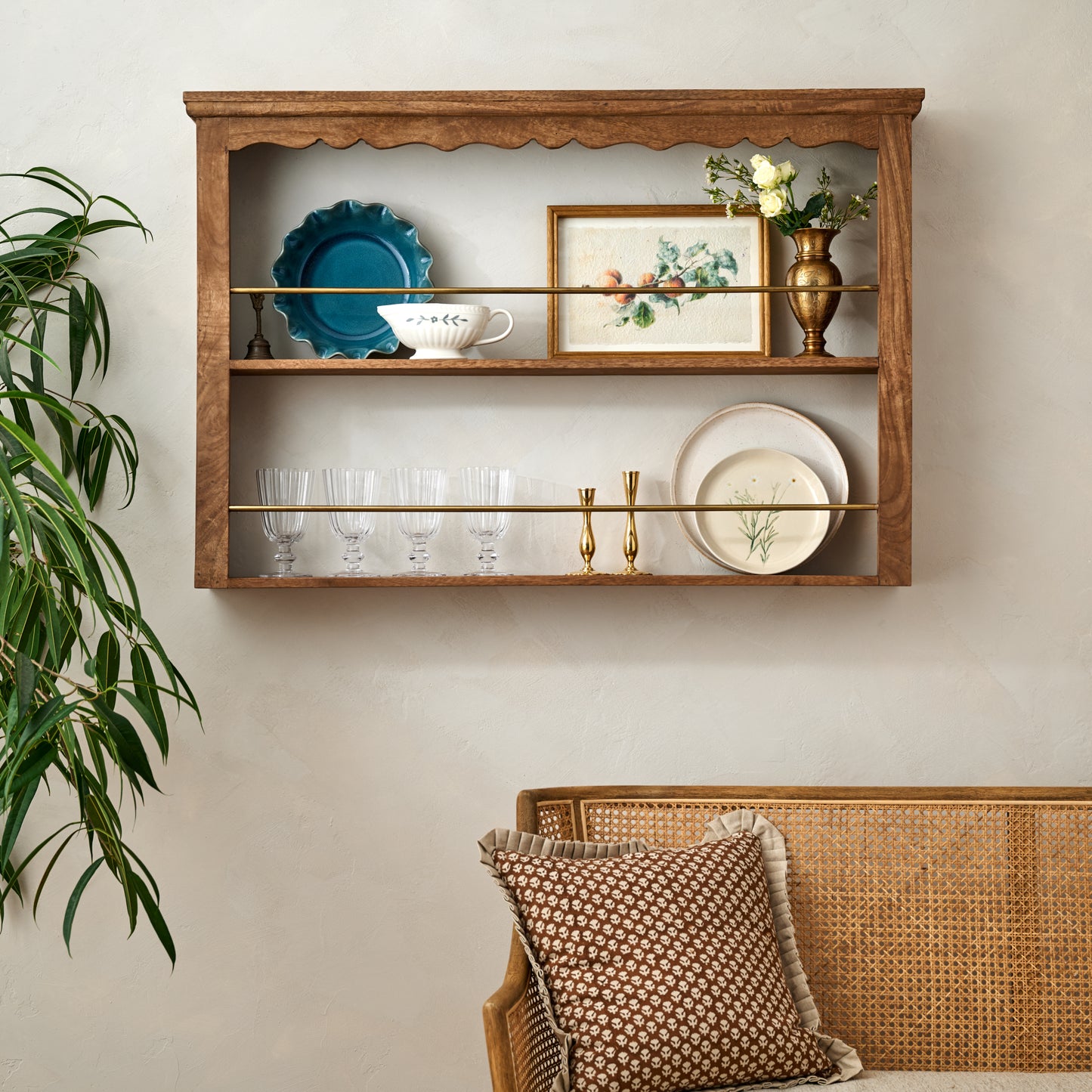 Jolene Wood and Brass Display Shelf styled with glassware, dinnerware and decorative accents. 