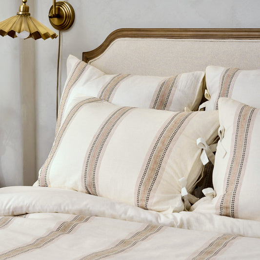 Dannie Stripe Sham on bed and pillows
