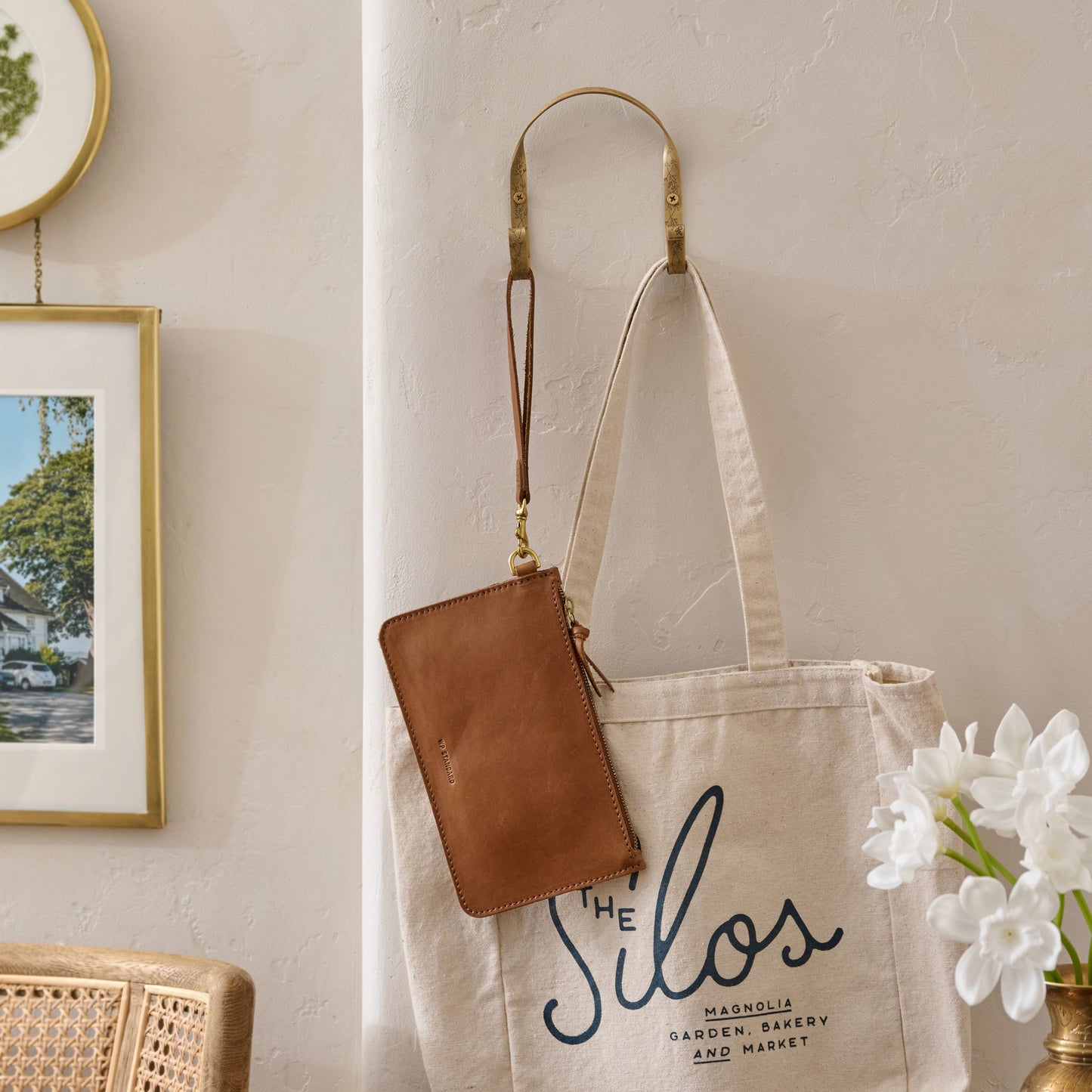 Celine Etched Brass Hook (Double) on wall with tote bag and wristlet placed