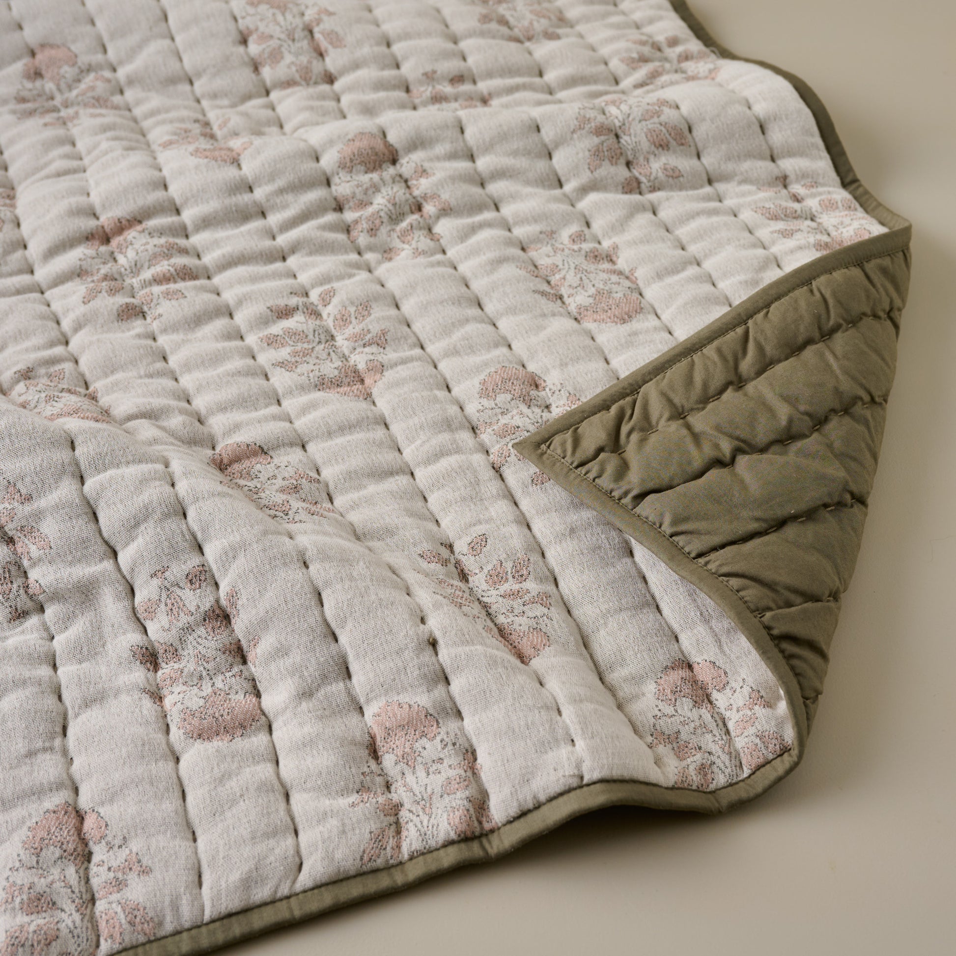 Floral Jacquard Kantha Quilt close up with olive green reversible