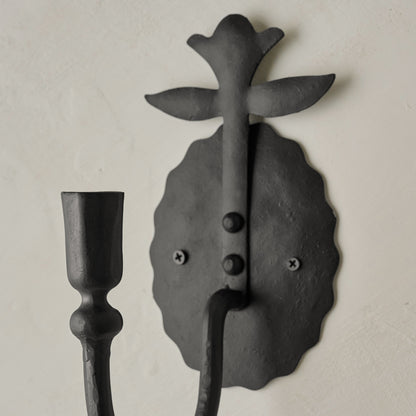 Antique Inspired Forged Iron Wall Sconce angled close up view