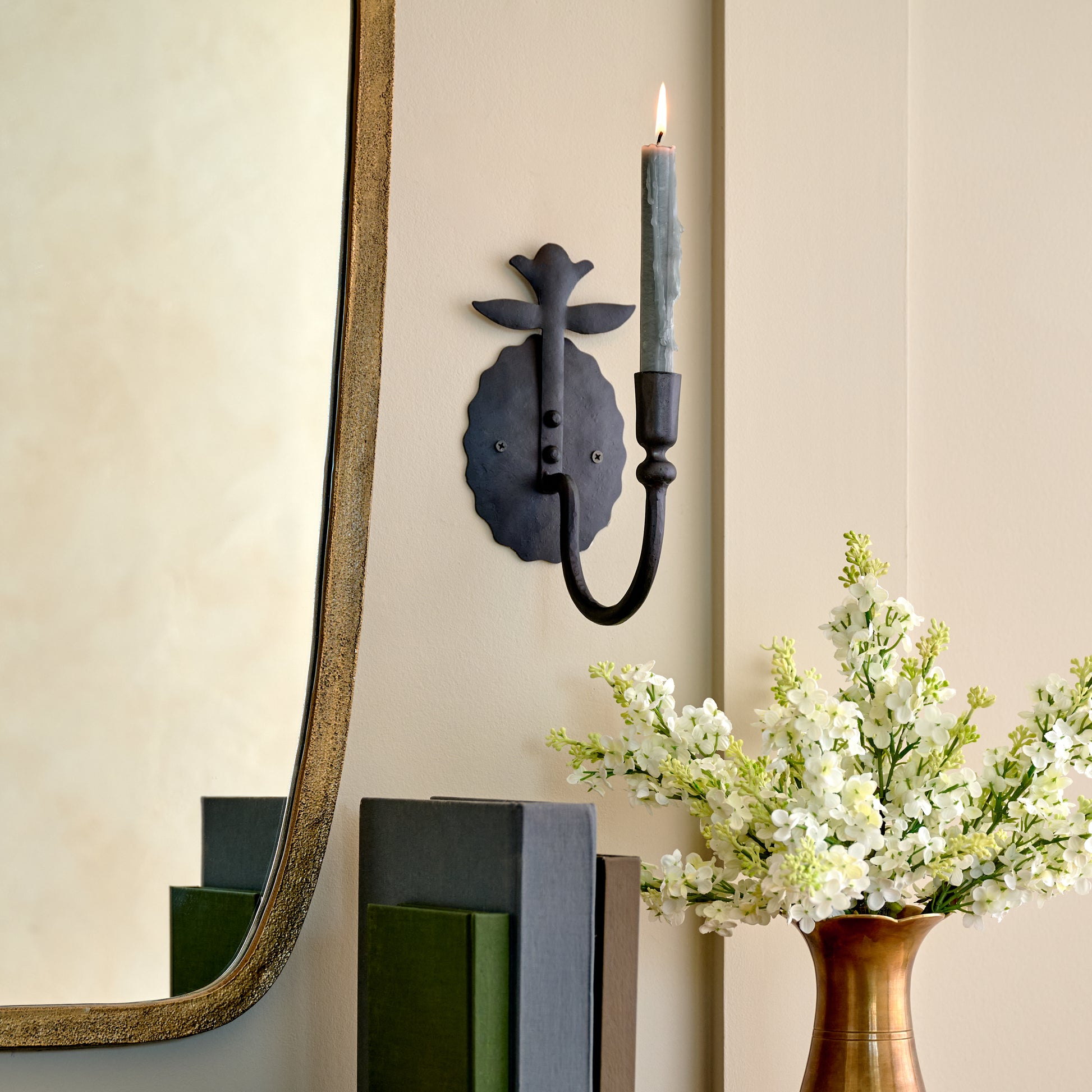 Antique Inspired Forged Iron Wall Sconce close up view in a room 