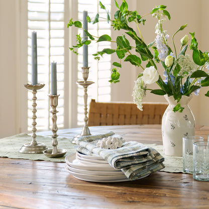 Cassandra Candle Holder styled on dining table with tabletop dinnerware, floral and vases
