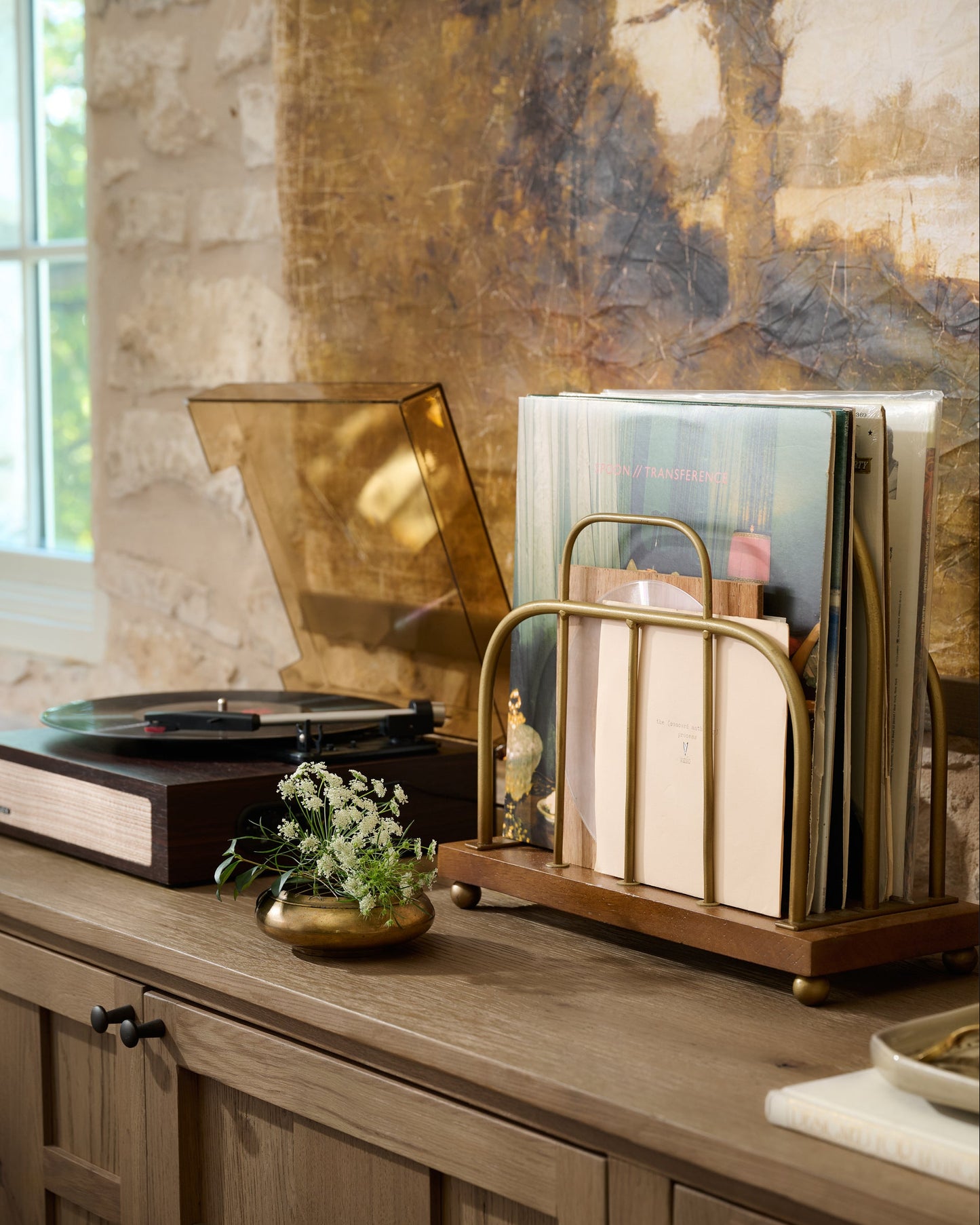 Short Antique Brass and Wood Media Stand holding vinyl records in a room