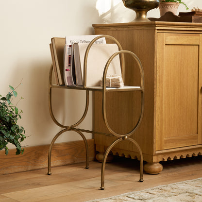 Juliet Marble and Brass Media Stand styled with books and magazines in a room