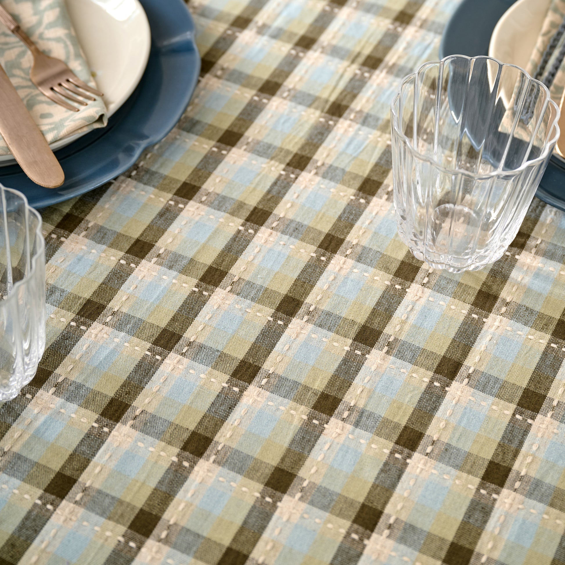 Olive Stone Tablecloth close up view scalloped glassware and dinnerware