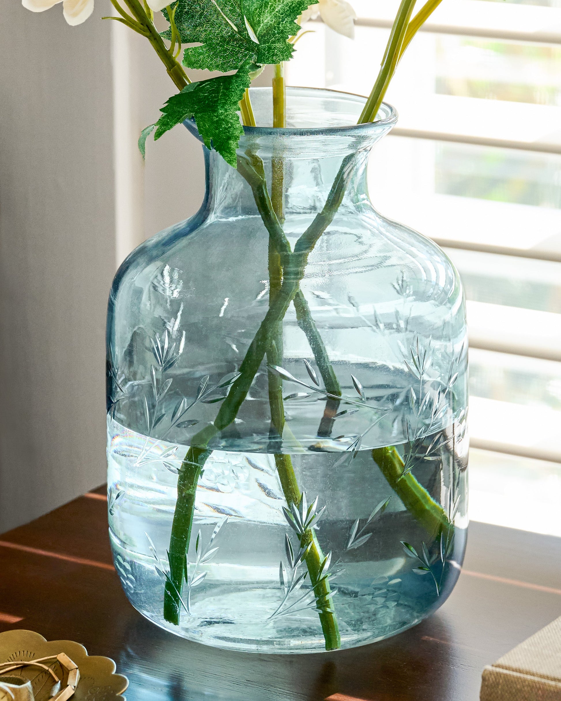 Nora Floral Etched Glass Vase filled with stems on tabletop