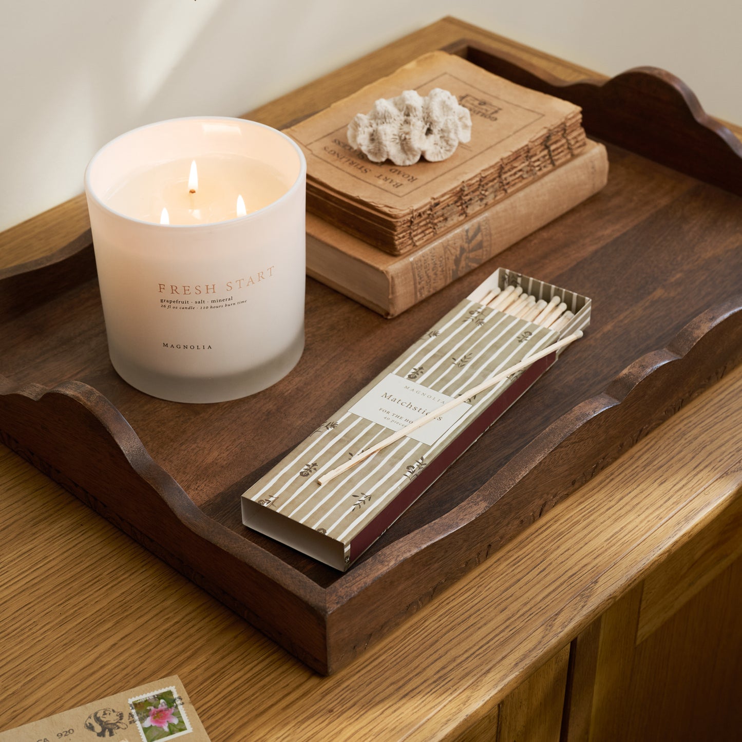  'Fresh Start' Candle on a wooden tray with green matchsticks.