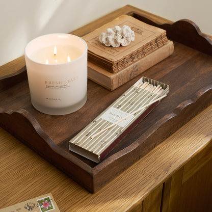  'Fresh Start' Candle on a wooden tray with green matchsticks.