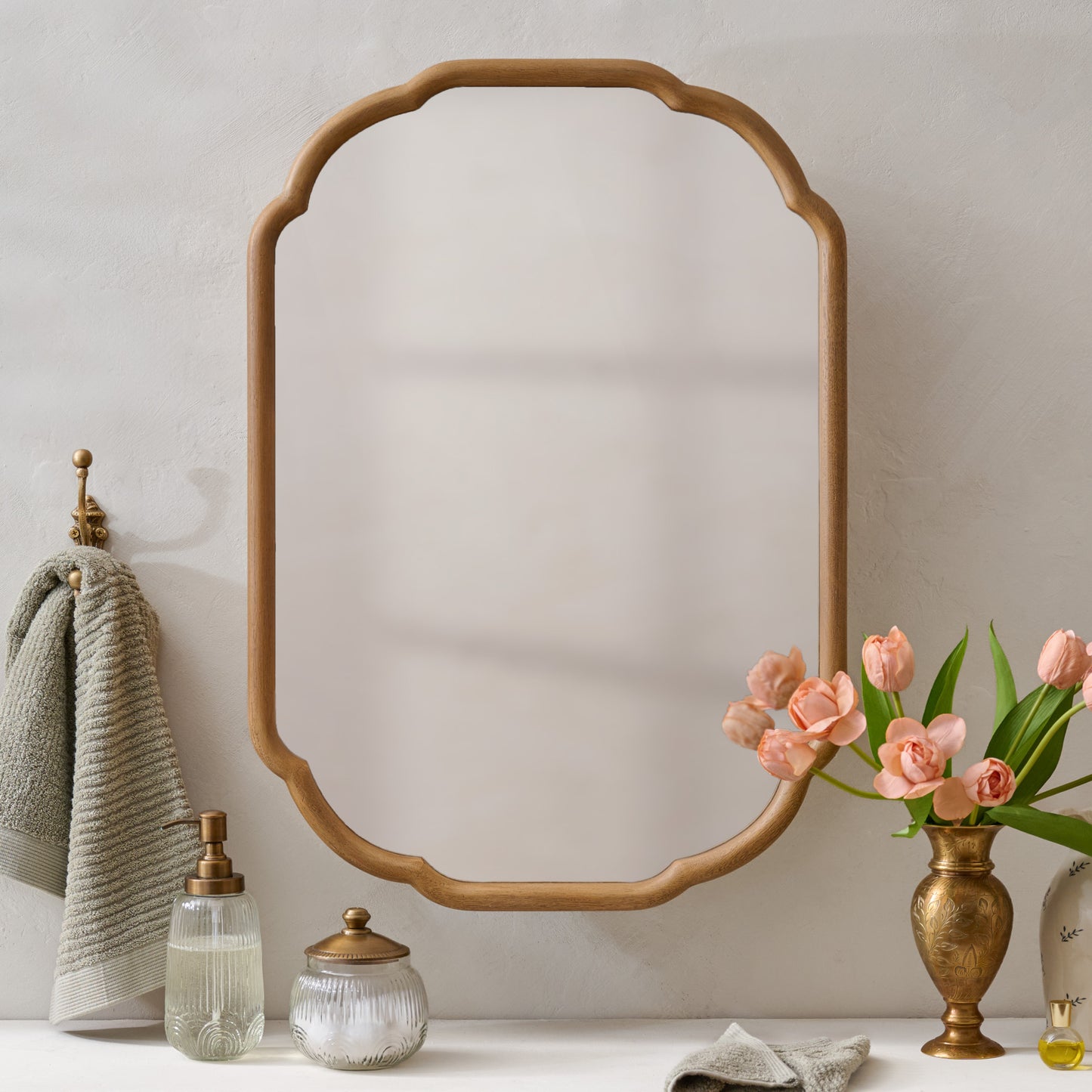 Greer Wood Scalloped Medicine Cabinet (Aged Natural) in bathroom with floral vase, wall hook and bath accessories