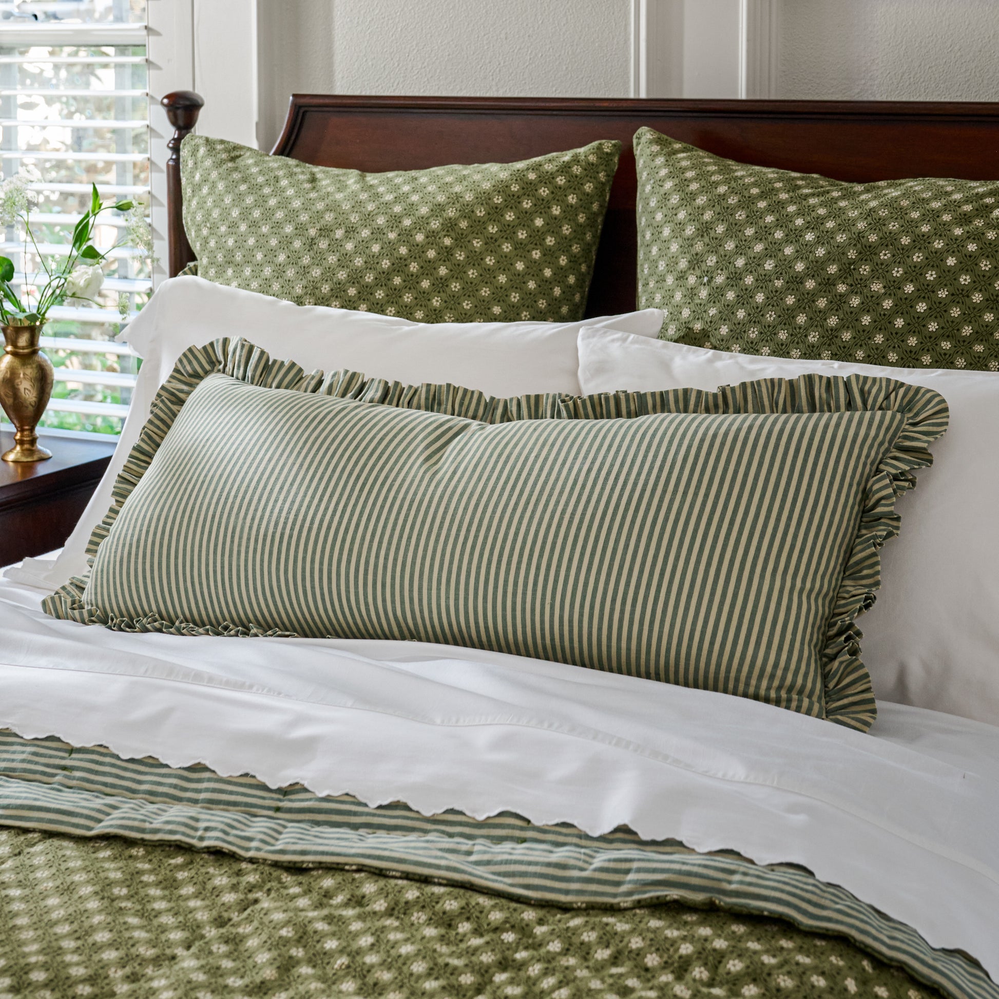 Thea Reversible Lumbar Pillow (large) stripe side featured on bed