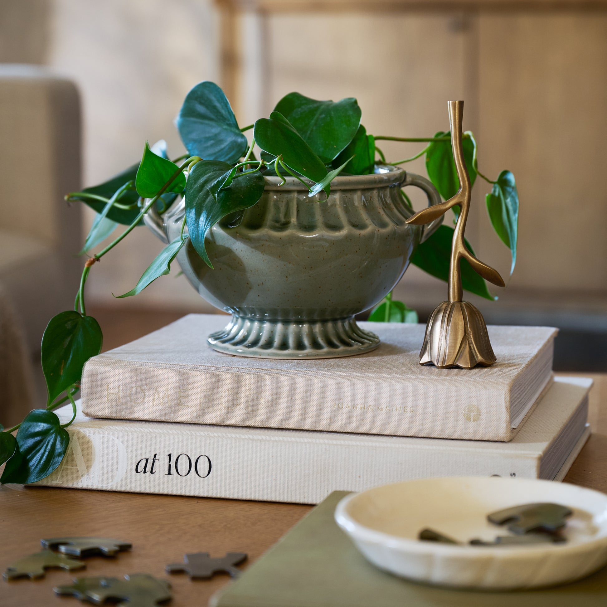 Floral Antique Brass Bell on coffee table with decorative books and vases