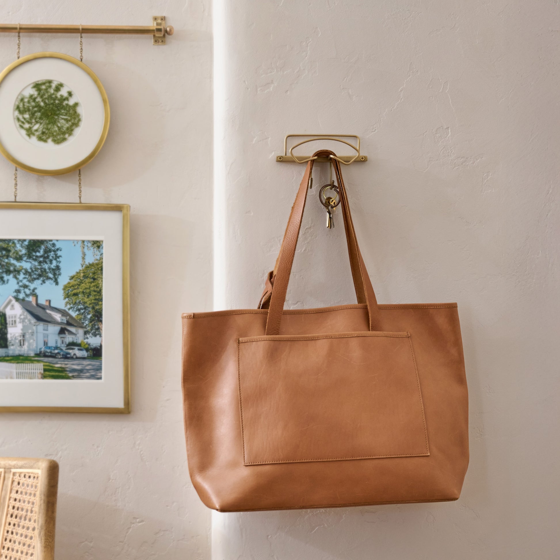 Antique Brass Wyatt Hooks (Single) on wall with leather purse and kays placed 