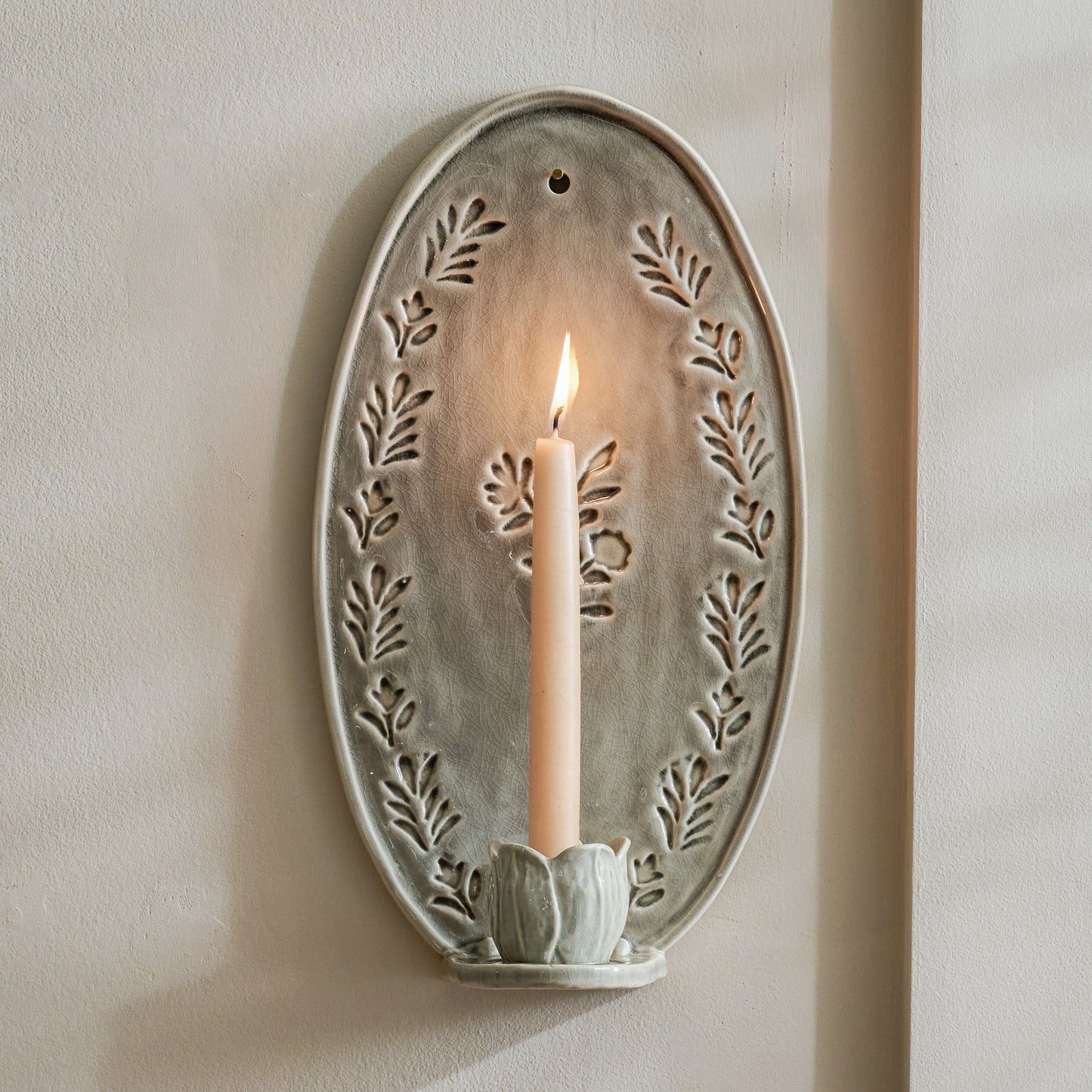 Hallie Floral Ceramic Wall Sconce with taper candle lit
