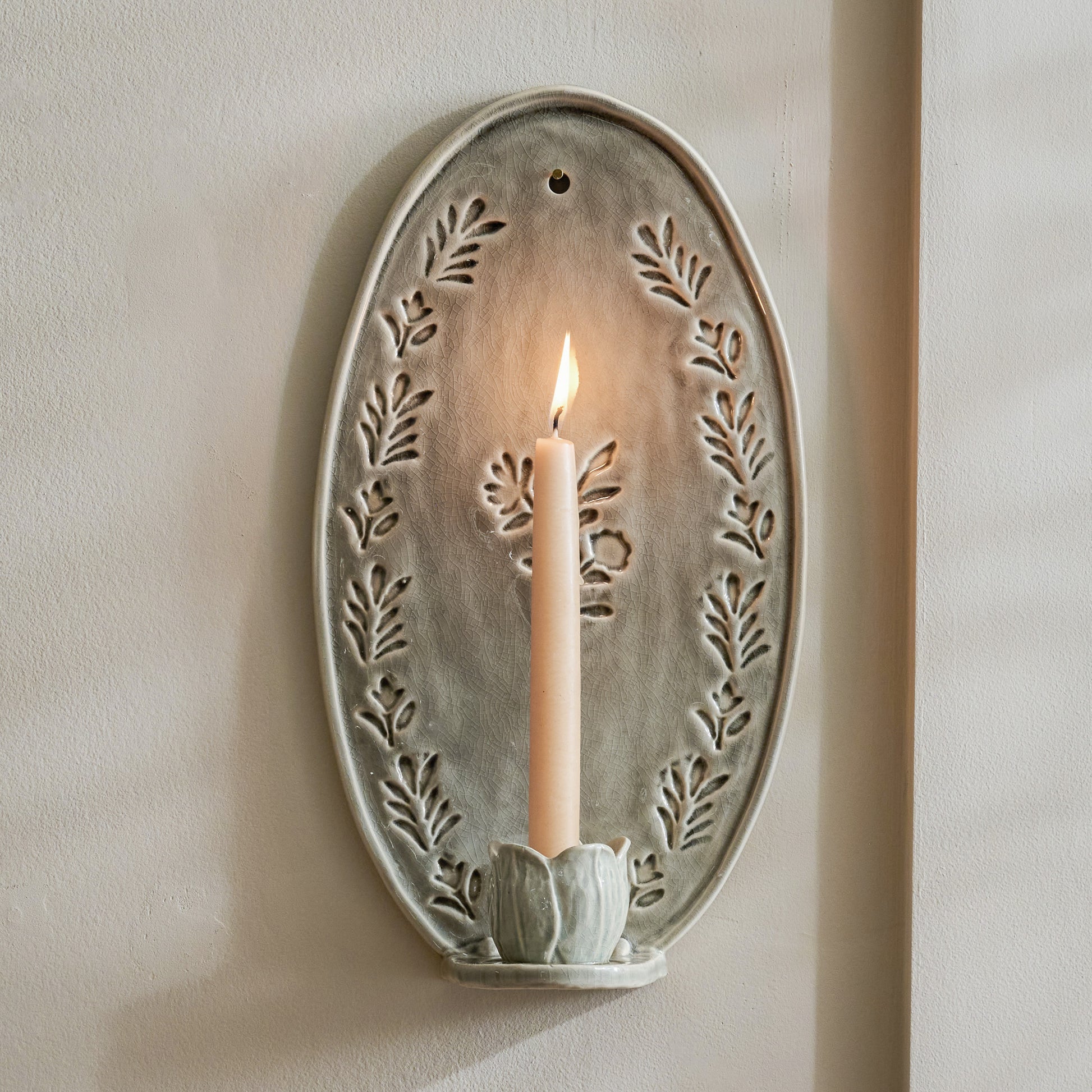Hallie Floral Ceramic Wall Sconce with taper candle lit