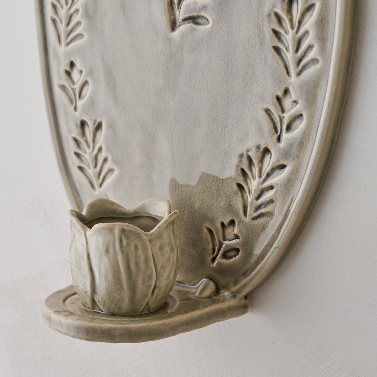 Hallie Floral Ceramic Wall Sconce close up view of tulip taper holder base