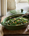 Cottage Collection Forest Green Oval Baking Dish with savory green beans inside 