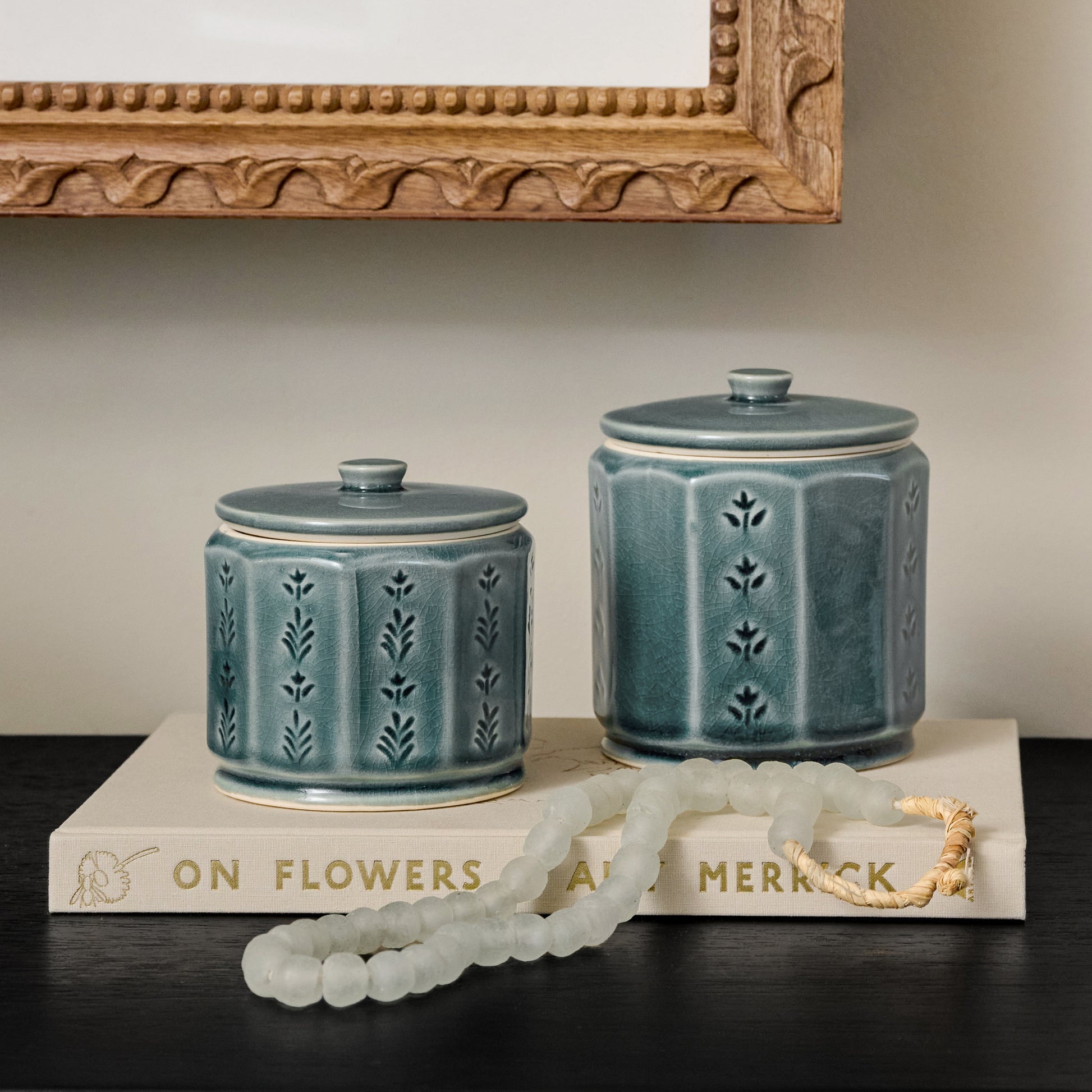 Harper Ceramic Floral Canister styled with decorative accessories in a room