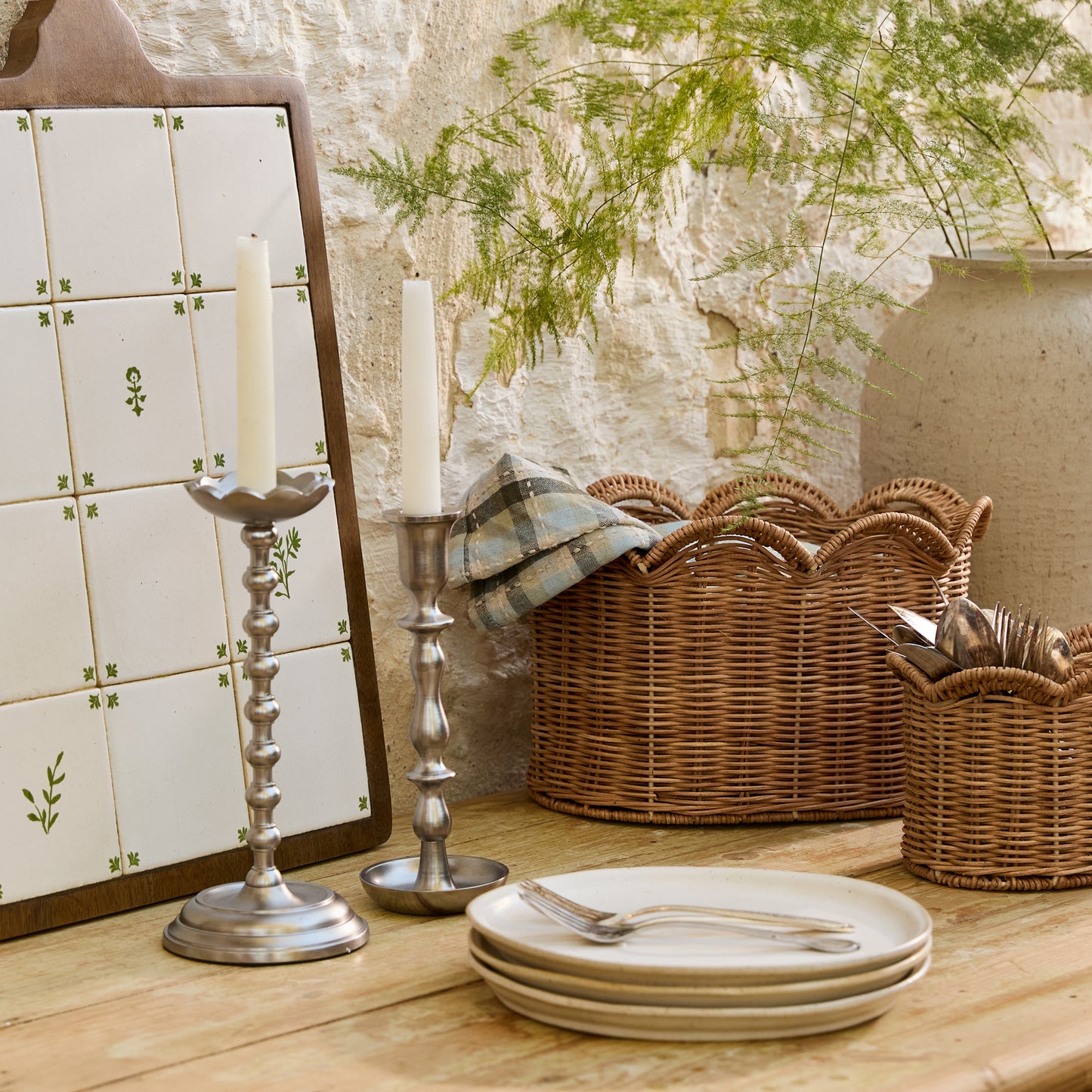 Lauren Scalloped Woven Canister (small and large) placed on table with table linens and serving boards