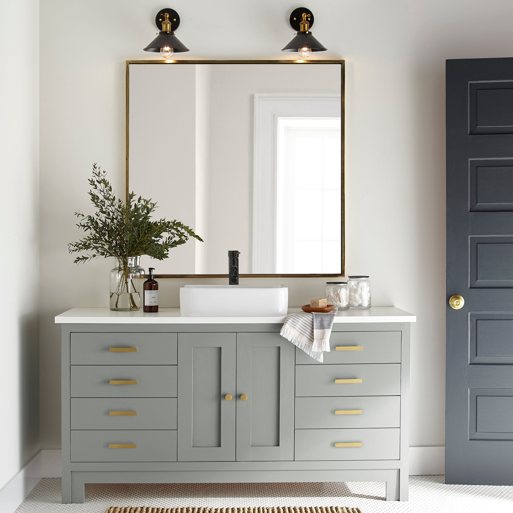 An overcast gray with hints of pale blue and green door and cabinet paint named weathered windmill shown painted on bathroom cabinet