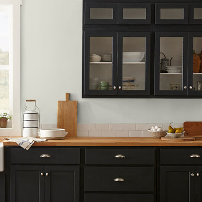 Warm white with a light beige tint interior paint named one horn white shown painted on a kitchen wall