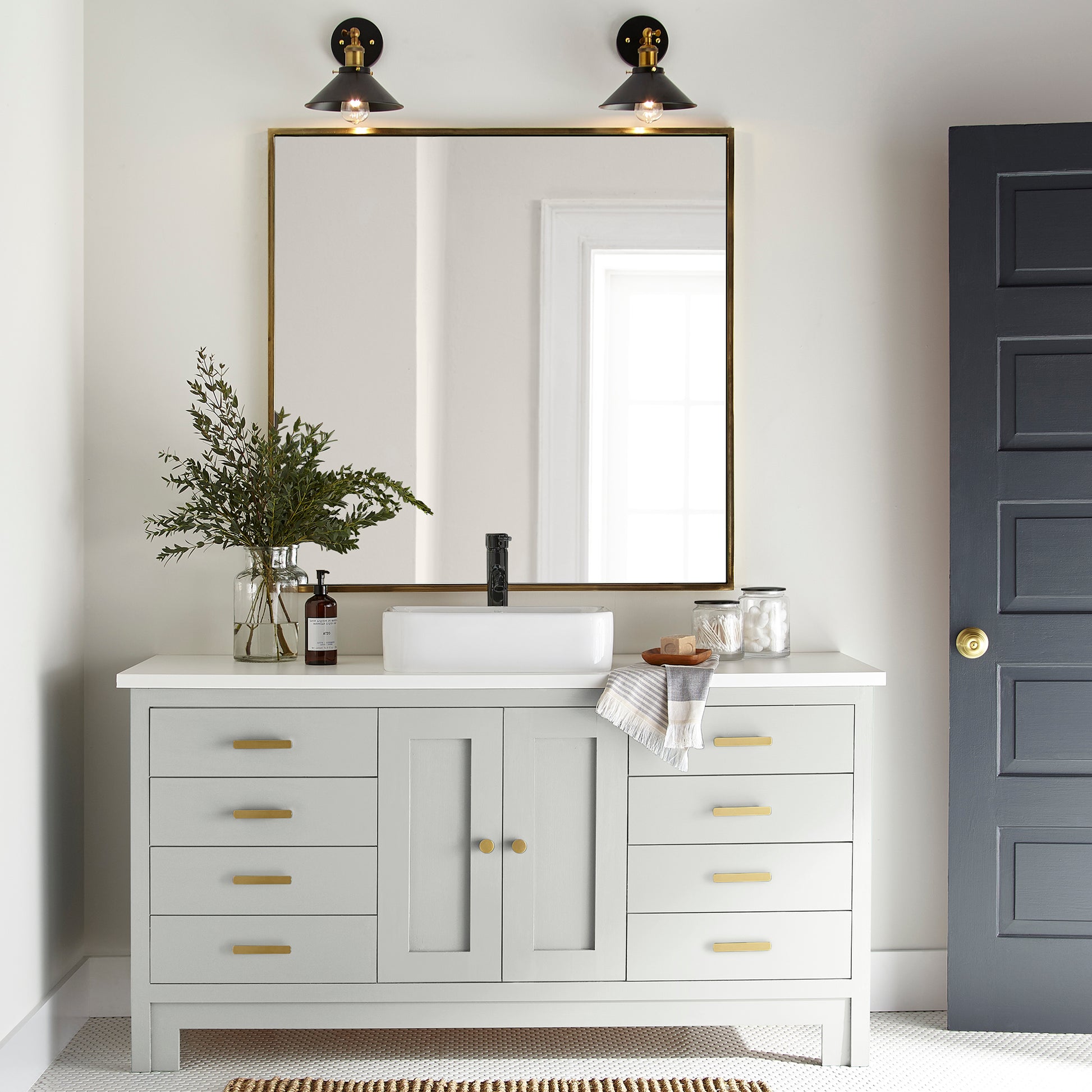 A pure white trim and cabinetry paint named true white shown painted on bathroom cabinet