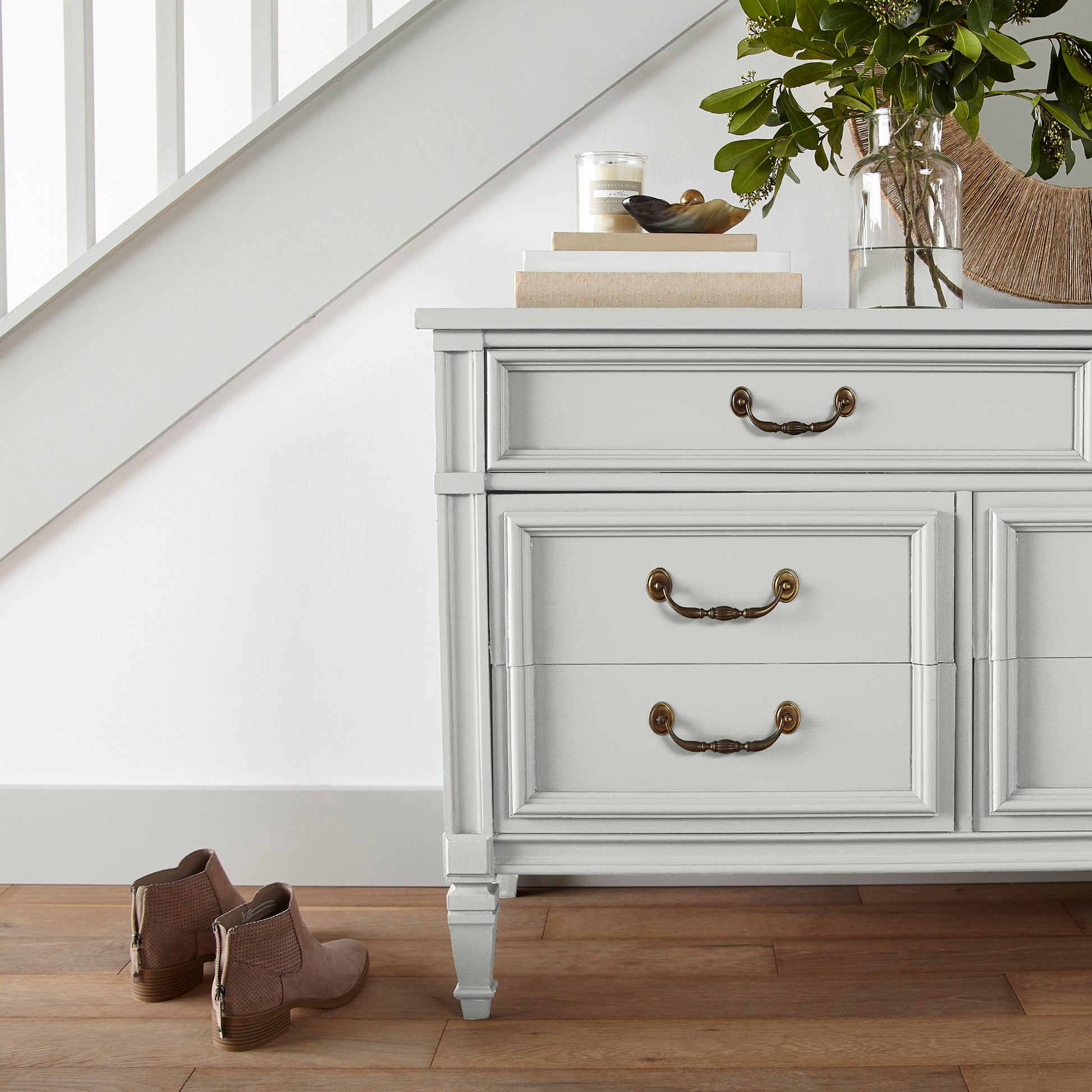 A pure white trim and cabinetry paint named true white shown painted on entryway cabinet