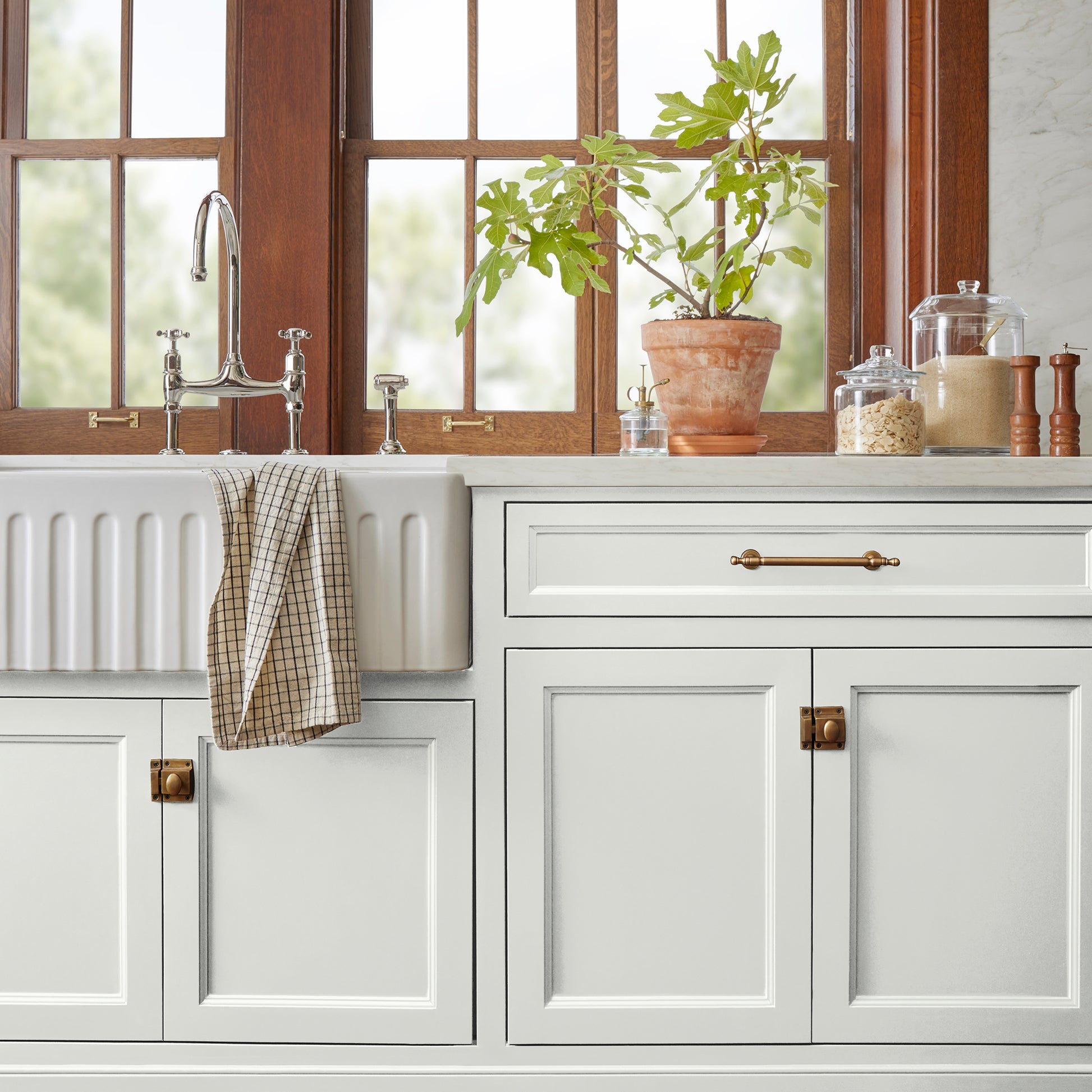 medium grey with tan undertones paint named gatherings shown painted on kitchen cabinet