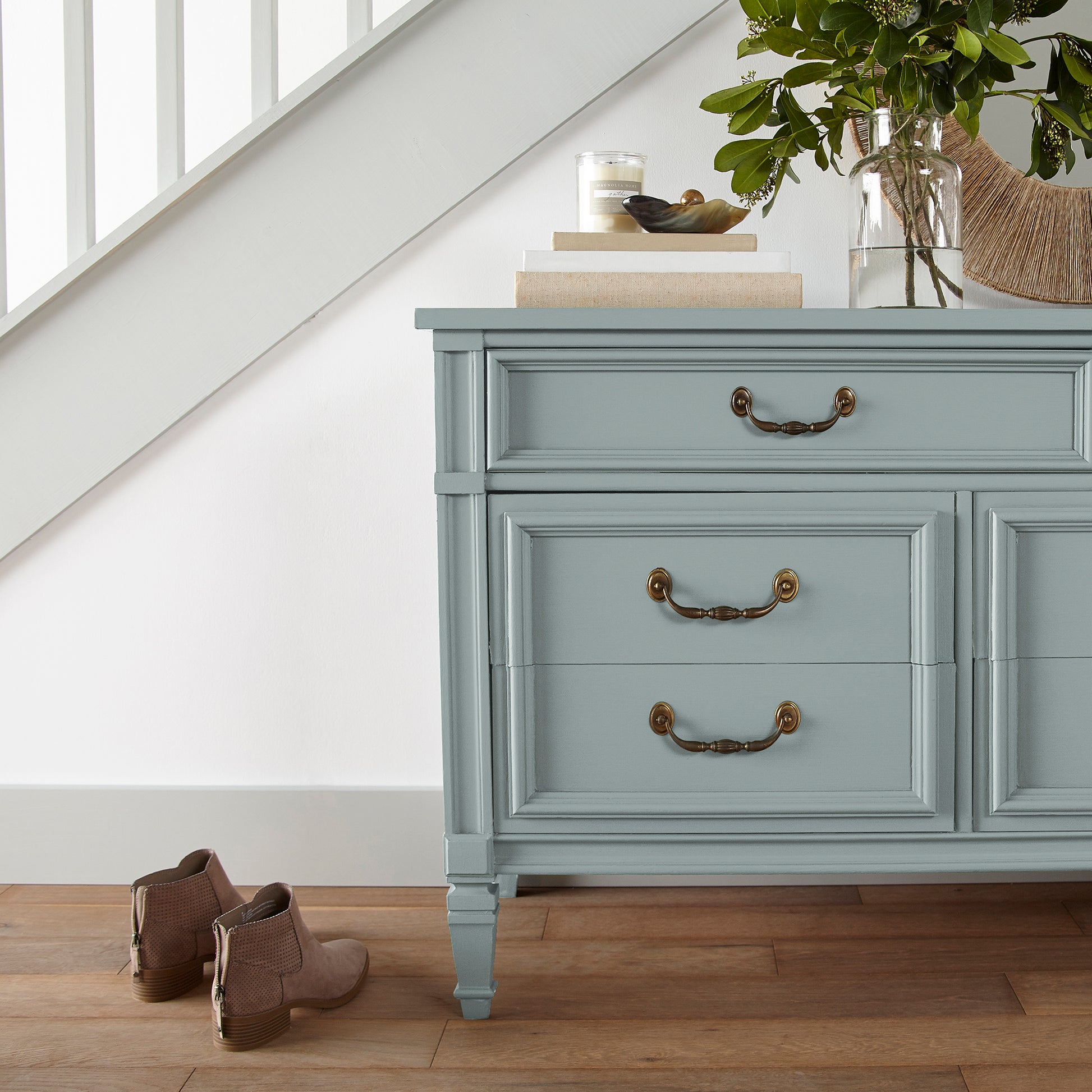 muted grey-blue paint named rainy days shown painted on entryway cabinet