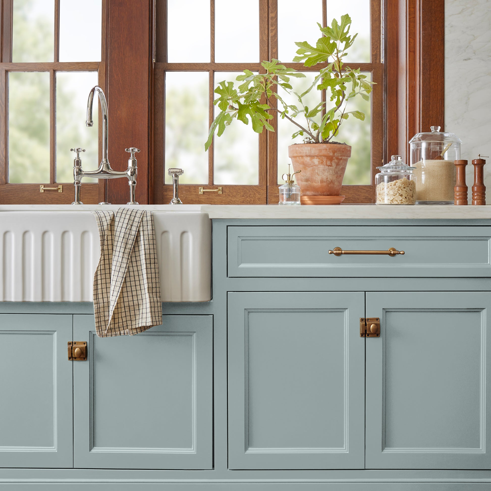 muted grey-blue paint named rainy days shown painted on kitchen cabinet