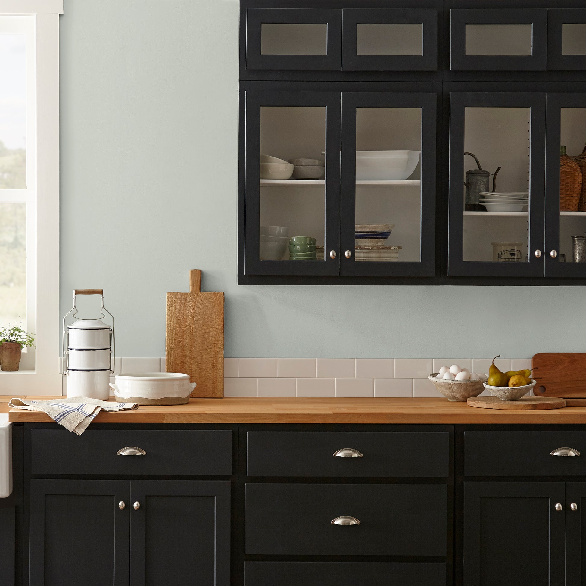 light blue grey with light green undertone interior paint named emmies room shown painted on kitchen wall