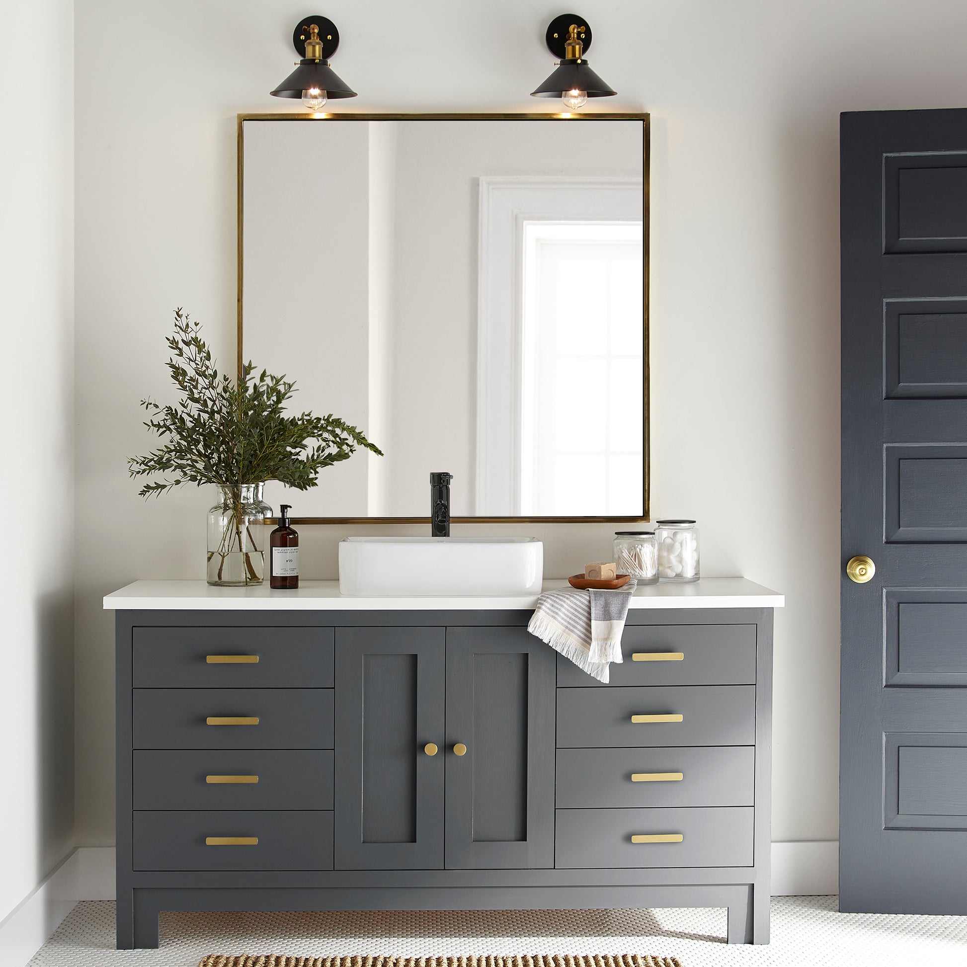 A dark chalkboard black with blue undertones paint named Blackboard shown painted on bathroom cabinet.