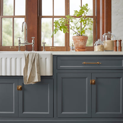 A dark chalkboard black with blue undertones paint named Blackboard shown painted on kitchen cabinet.