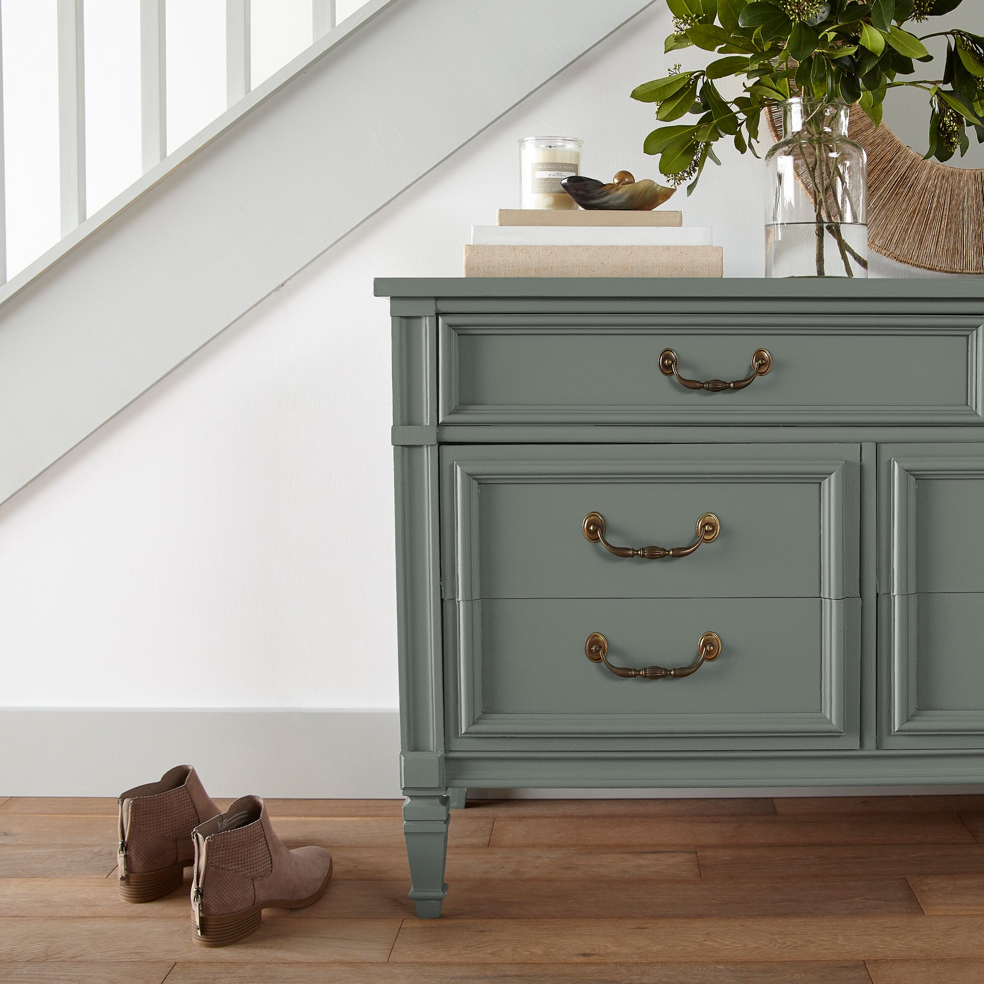 a dark green-grey door and cabinet paint named luxe shown painted on entryway cabinet