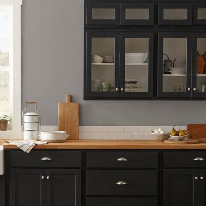 dark grey with olive-brown undertones paint named garden trowel shown painted on kitchen wall