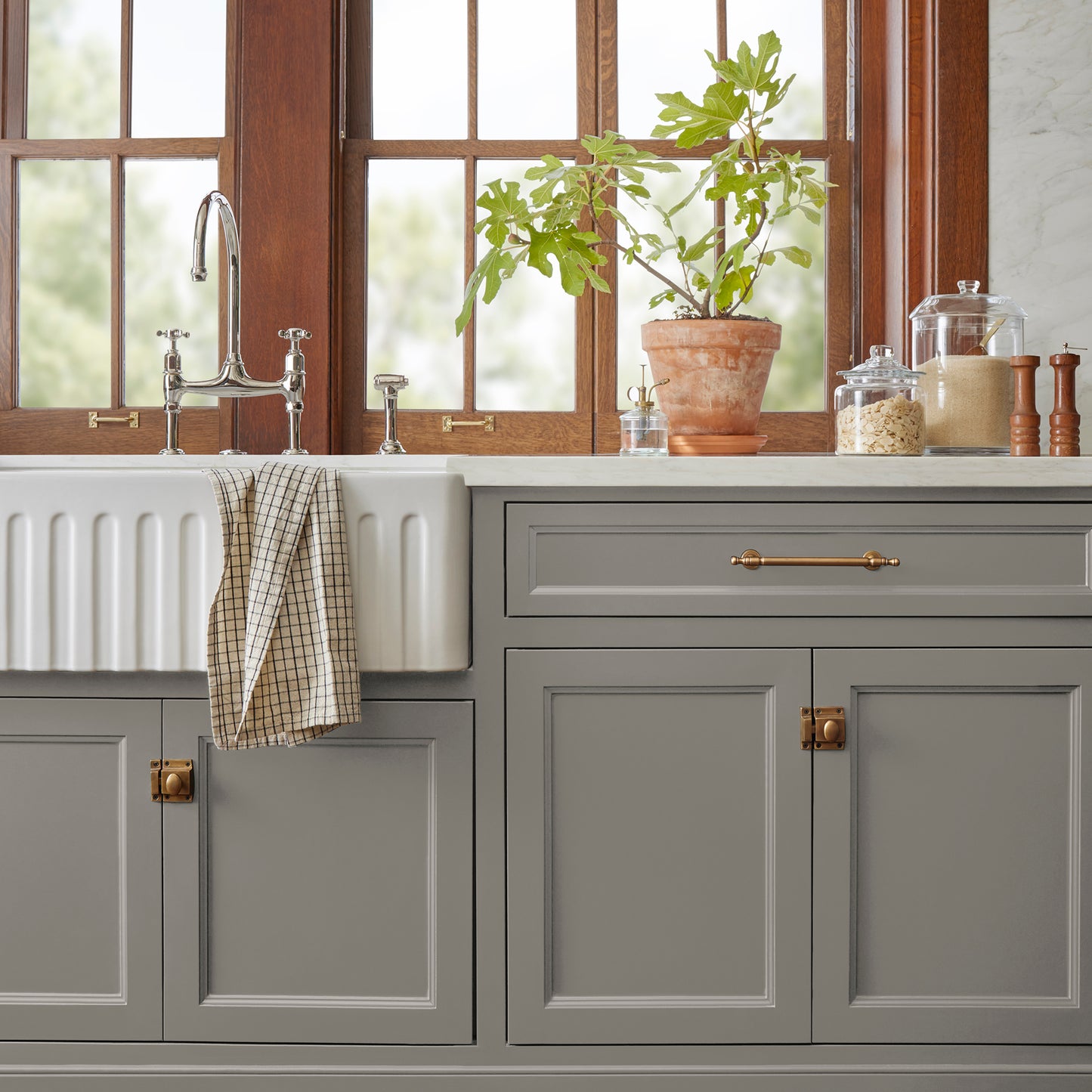 dark grey with olive-brown undertones paint named garden trowel shown painted on kitchen cabinet
