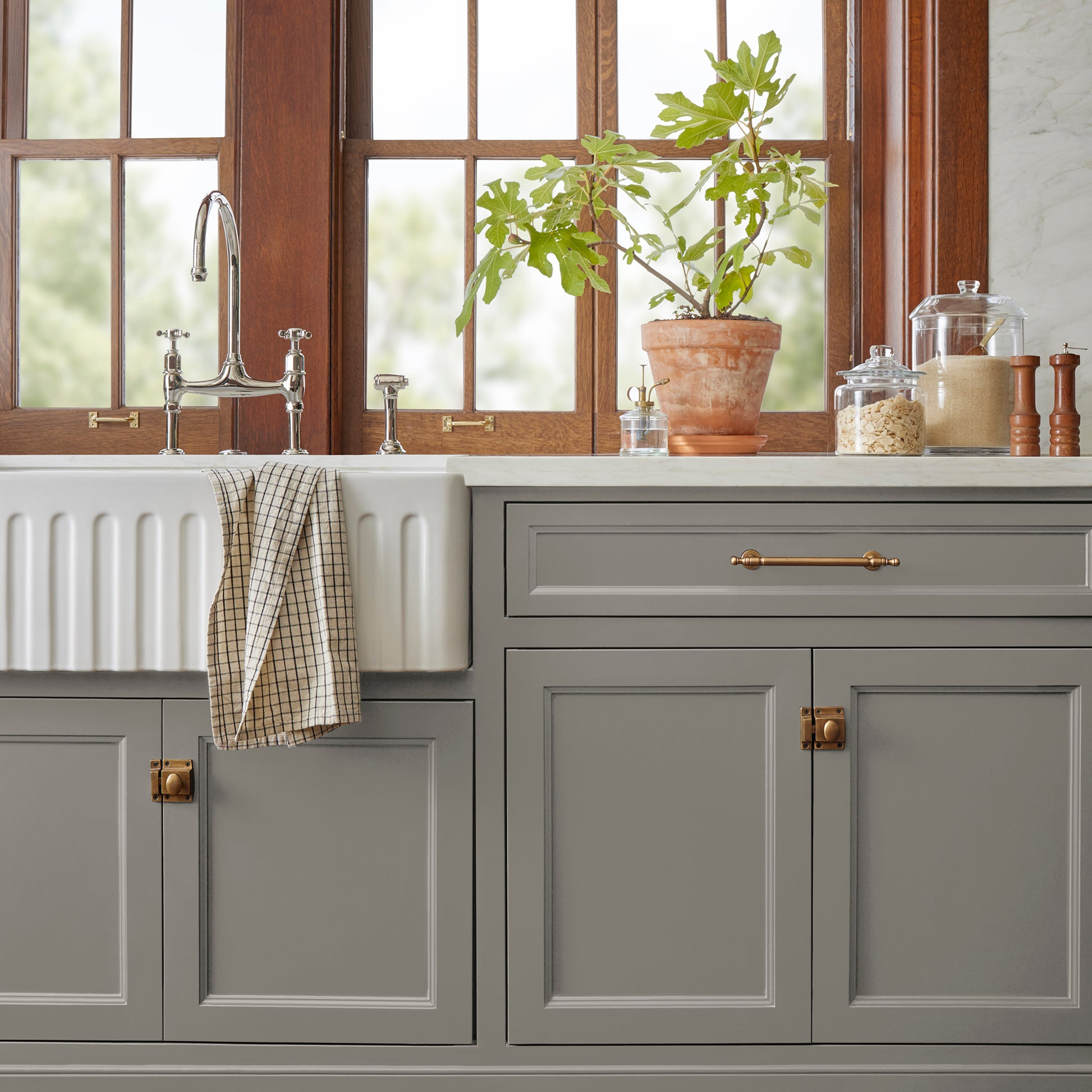 dark grey with olive-brown undertones paint named garden trowel shown painted on kitchen cabinet